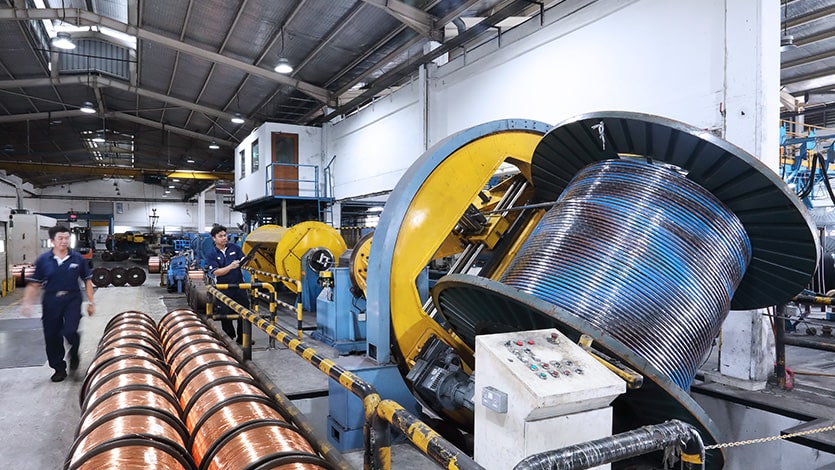 Tai Sin Electric employees operate high tech manufacturing machinery to manufacture cables