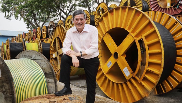 Mr Lin Chen Mou, Tai Sin’s Executive Vice President and General Manager, poses in front of rolls of electric cables