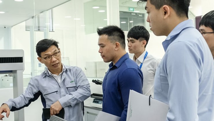 Trainees listen as a trainer shares more about 3D printers and other additive manufacturing equipment in a smart factory