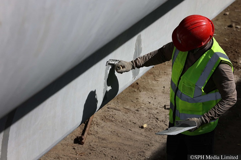 A worker conducting quality checks on a bridge segment at the Coinico yard