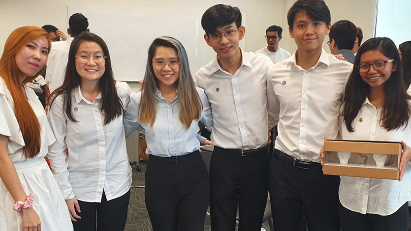 A team of students from Temasek Polytechnic show off a new product packaging that they designed for ACE Power