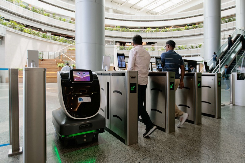A delivery robot navigates turnstiles as part of a trial.