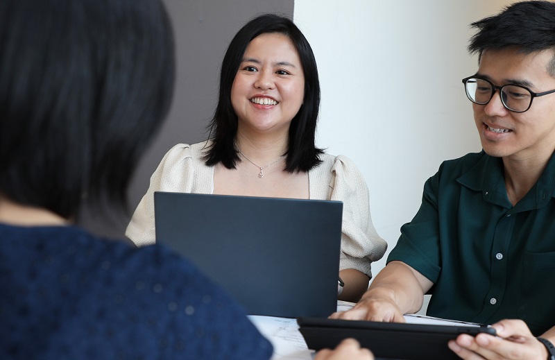 Winnie Chu, a senior engineer involved in the development of Punggol Digital District, is engaged in a lively discussion with her colleagues.